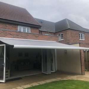 Intelroll Retractable Awnings INT500 grey fabric white frame 3.5m width front view opened 01