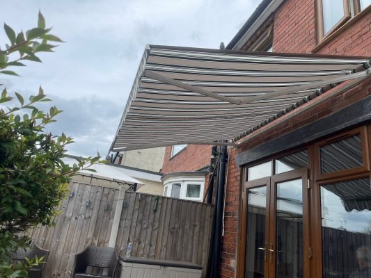 INT400 awning intelroll canopy for garden and patio shading water resistant fabric stripes retractable arms UK Wales NP26