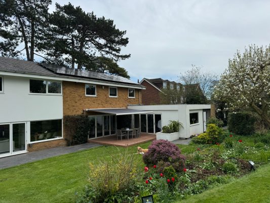 Awning installation, UK, Electric awning with white frame