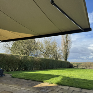 INT500 full cassette patio awning, grey frame, Acrylic creme fabric with LED lights, St Albans