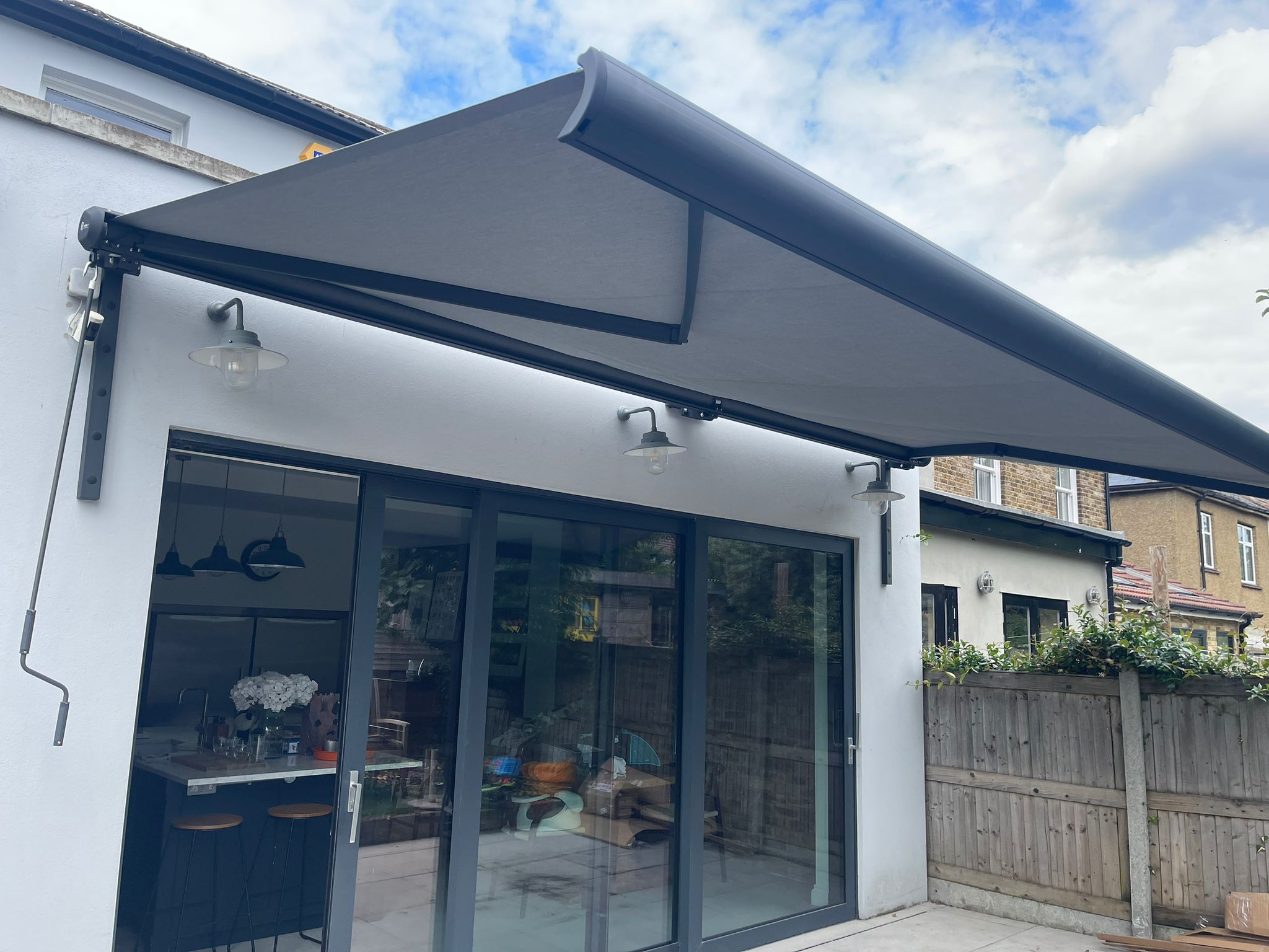 Spreader Bracket - Standard Stright installed on Intelroll Awnings retractable for wall colour grey black Spreader Bracket - Standard Stright installed on Intelroll Awnings retractable for wall colour grey black
