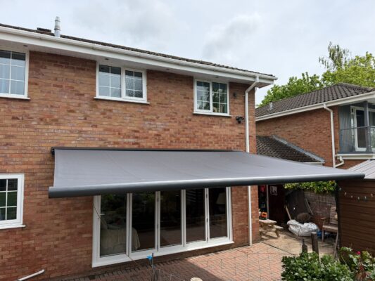 Dorchester DT2 8UX Interoll Awning COLOUR GREY RETRACTABLE INT500 SLIDING DOOR OPENED AWNING INSTALLED 14TH MAY 2026